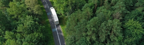 truck driving through forest