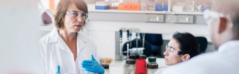 Woman working in pharma talking to staff