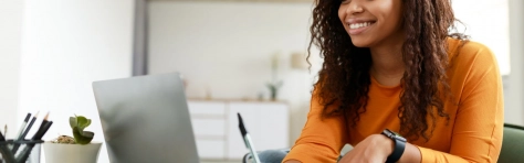 Girl in education making notes from laptop