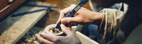 person carving pottery