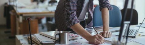 man working with laptop and pen