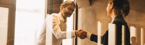Financial planner shaking hands with client