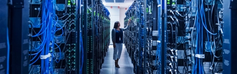 A professional woman checking a computer server